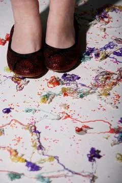 Close up of red shoes surrounded by confetti Stock Photos