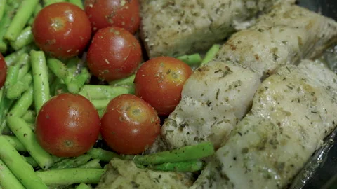 Close-up, Red Snapper Steak, Asparagus, and Tomatoes in a Iron Pan. Stock Footage 319257410