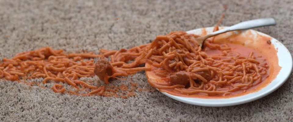 Close up of red spaghetti with fork and spoon on white background Foto stock