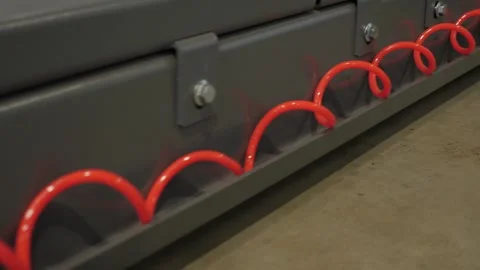 Close-up of a red spiral wire at a car service station, tire service. Stock Footage 337734050