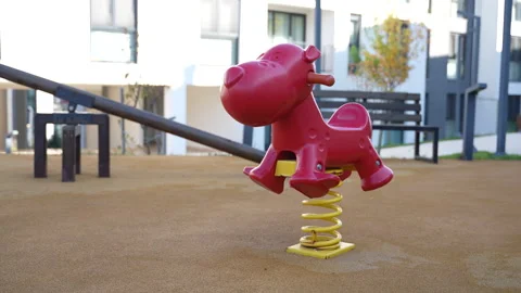 Close-Up of Red Spring Rider in Apartment Playground Stock Footage 311038692