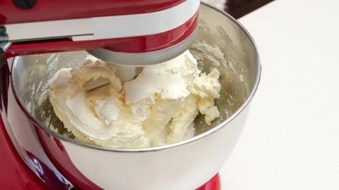 Close-Up of a Red Stand Mixer with a Silver Bowl Filled with Fluffy Whipped C Stock Photos