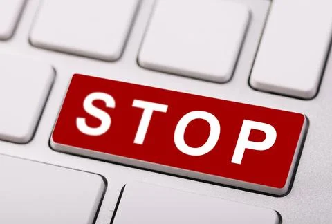 Close-up of a red "STOP" button on a computer keyboard, symbolizing caution.. Stock Photos