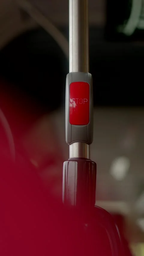Close-up of red stop button on metal pole in public transport Stock Footage 347202649