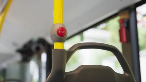Close up on red stop button on public bus during a ride in the street Stock Footage 218461159