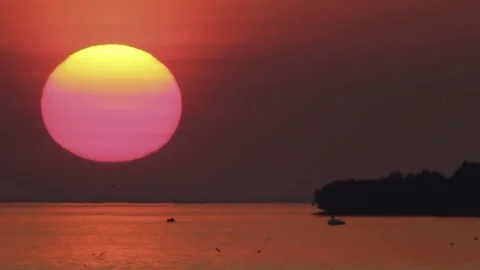Close-up Red Sun Goes Down At Sea Sunset Next To An Island Stock Footage 168174010