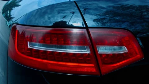 Close up of red tail light of a car. Car details presentation in slowmotion Stock Footage 143796527