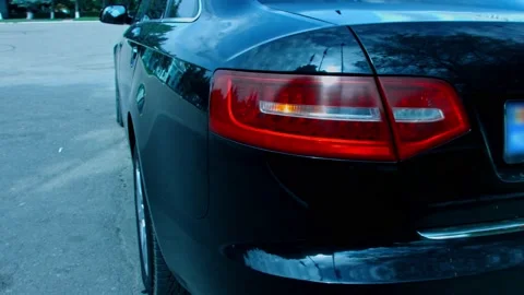 Close up of red tail light sof a car blinking. Car details presentation in Stock Footage 143796928