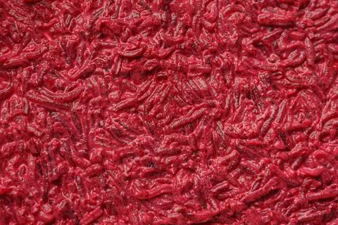 Close-up of a red textured abstract background with various fragments scatter 库存照片