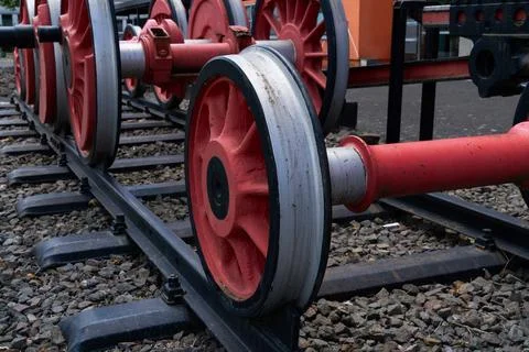 Close-up of red train wheels on a set of tracks. Stock Photos