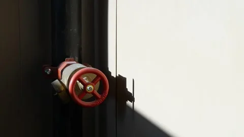Close-up of a red valve pipe in bright sunlight Video stock 276341761