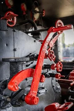 Close-up of red valves and control mechanisms inside a steam locomotive cab Stock Photos