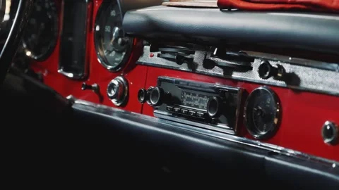 Close-up of red vintage car dashboard panel showing gauges and controls Video stock 340879929