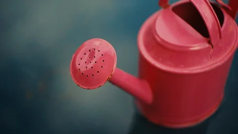 Close up of red watering can. slider shot Stock Footage 121533060