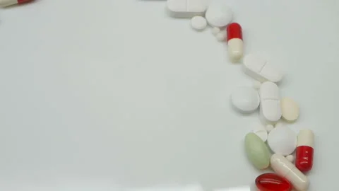 Close up, with red, white, colored pills rotating, from the right side, copy spa Stock Footage 86213664
