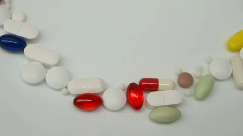 Close up, with red, white, colored pills rotating, from the the top side, copy s Stock Footage 86213784