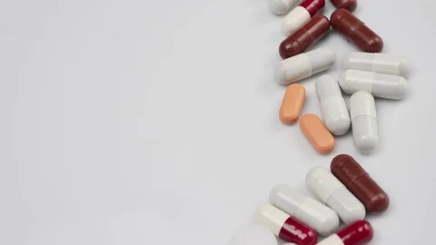 Close up, with red, white, pills rotating, from the right side Stock Footage 81007387