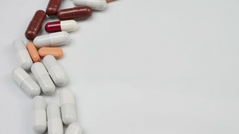 Close up, with red, white, pills rotating, from the left side Stock Footage 81007431