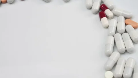 Close up, with red, white, pills rotating, from the right side Stock Footage 81049004