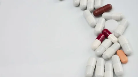 Close up, with red, white, pills rotating, the right side Stock Footage 81049618