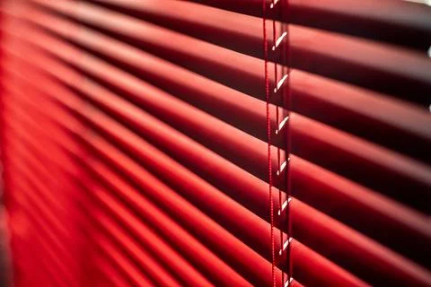 Close Up of Red Window Blinds with Soft Lighting Stock Photos