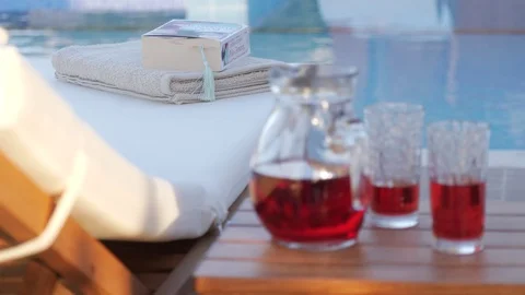 Close up of red wine by the pool Stock Footage 97010258