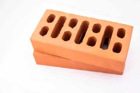 Close-up of reddish perforated bricks for building and real estate constructi Stock Photos