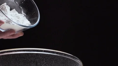Close up of refined white flour falling on a black background Stock Footage 72471234