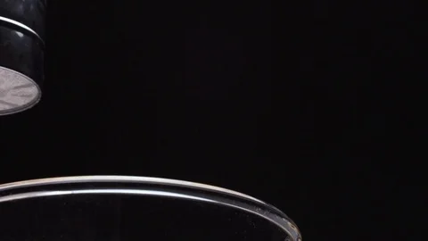 Close up of refined white flour falling through metal sieve on black background Stock Footage 72471466