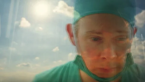 Close up reflection of a doctor looking out of a window Video stock 87022481