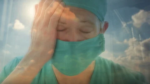 Close up reflection of a doctor looking out of a window Video stock 87025488