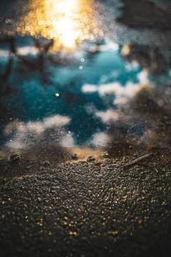 Close-up reflection of sky on puddle Stock Photos