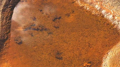 Close-Up of Reflective Muddy Pool on Riverbank with Clay Textures in Tambopata, 스톡 동영상 314320564