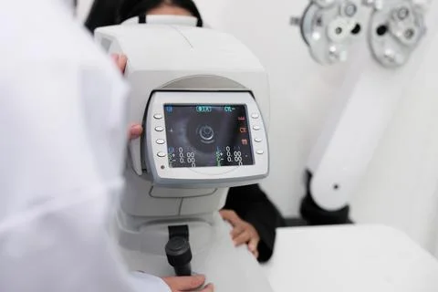 Close-up, refractometer device screen of patient eye exam in optical clinic. Stock Photos