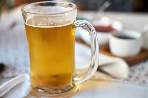 Close-up of a refreshing cold beer mug on a table in a pub Stock Photos