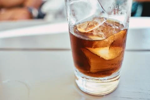 Close-up of a refreshing cold cola drink with ice cubes in a glass Stock Photos