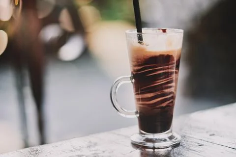 Close-up of a refreshing iced chocolate drink served in a tall glass with a.. Stock Photos
