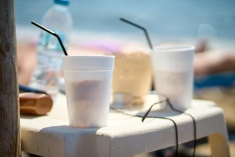Close-up of refreshing iced coffee drinks in white plastic cups on a table .. Stock Photos