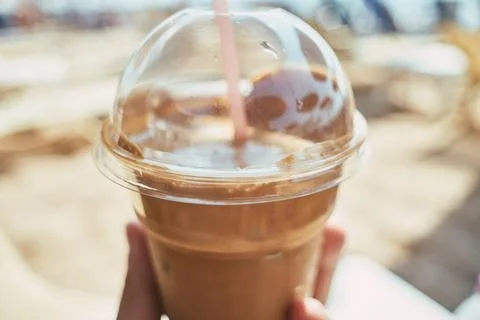 Close-up of a refreshing iced coffee in a plastic cup with a straw Stock Photos