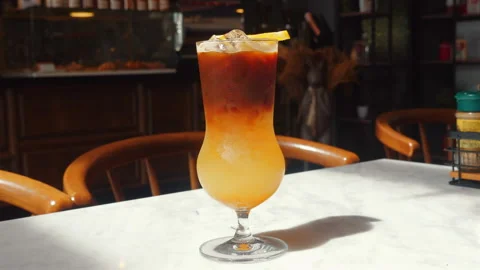 Close-up of refreshing iced tea in tall glass with lemon garnish, Stock Footage 282083258