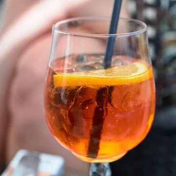 Close-up of a refreshing orange spritz cocktail with ice cubes and an orang.. Stock Photos
