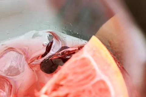 Close-up of a refreshing pink gin cocktail garnished with a slice of citrus.. Stock Photos