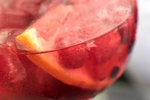 Close-up of a refreshing pink gin cocktail garnished with fresh raspberries.. Stock Photos
