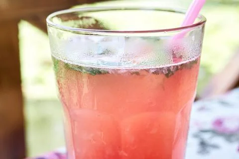 Close-up of a refreshing raspberry lemonade drink in a cold glass with straw Stock Photos