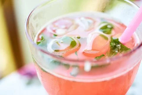 Close-up of refreshing raspberry lemonade with mint and ice in a glass cup Stock Photos