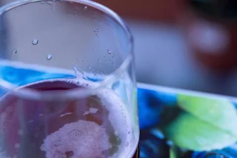 Close-up of refreshing red drink with foam and condensation Stock Photos
