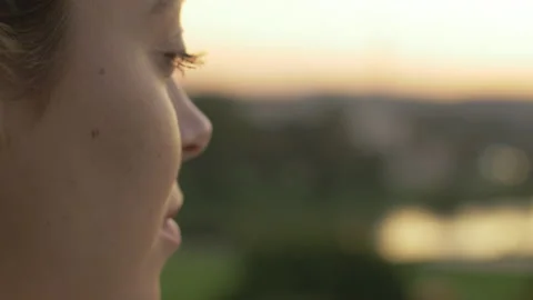 Close-up of relaxed dreamer looking forward at sunset 스톡 동영상 133170289