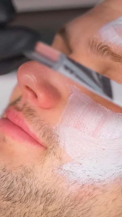 Close-up of a relaxed man's face while putting a mask on his face. A man at an Stock Footage 250382252