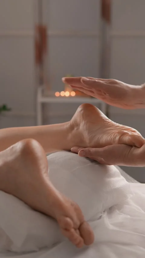 Close up of a relaxing foot massage session in a cozy spa environment, focusing Stock Footage 340923282