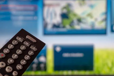 Close-up of remote control and watching smart tv Stock Photos